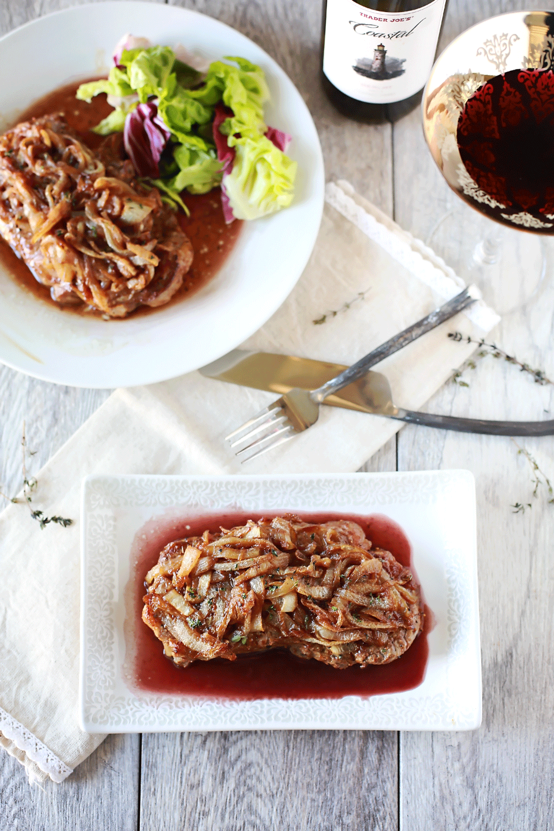 Caramelized Onions atop a gorgeous pan roasted steak resting in a Merlot reduction. An amazing recipe for those who love food, cooking and wonderfulness. By Flirting with Flavor.
