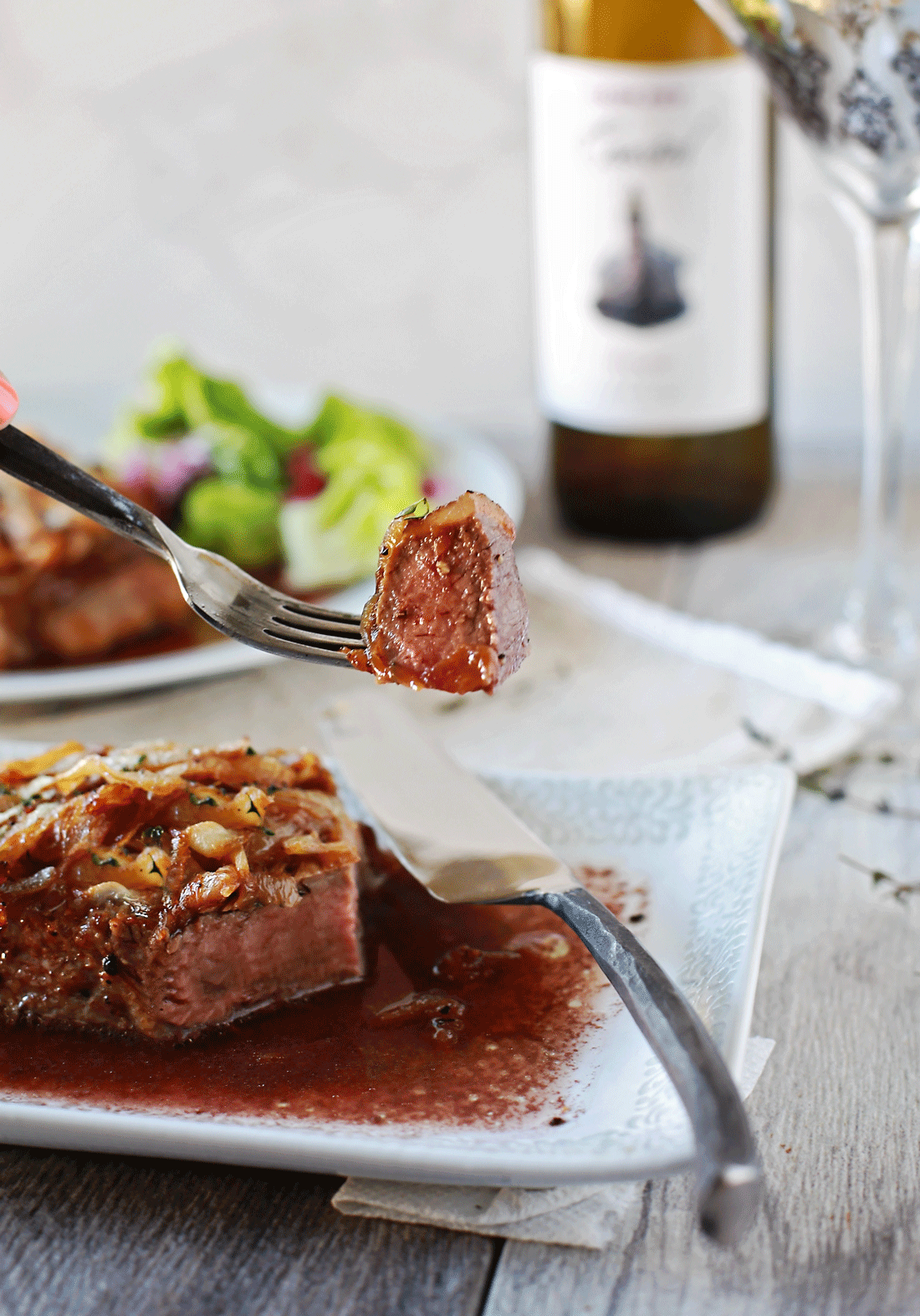 Steak with Caramelized Onions and a Merlot Reduction Tangled with Taste