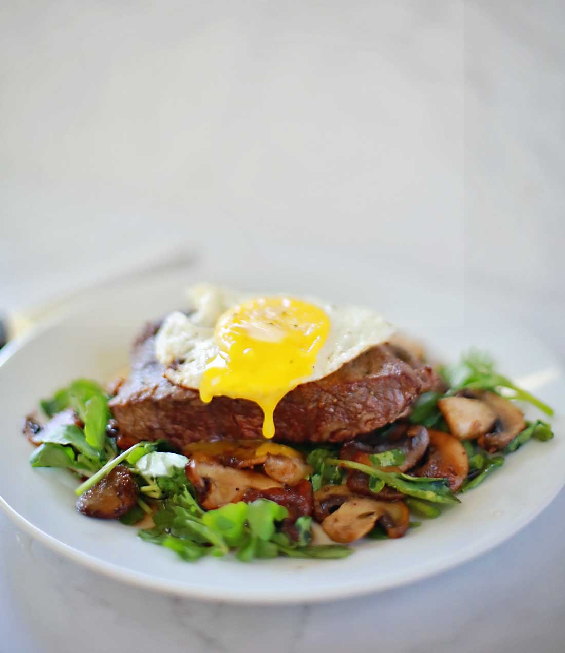 Steak and Eggs with mushrooms on a watercress salad! Sooo good and only takes ten minutes!!!