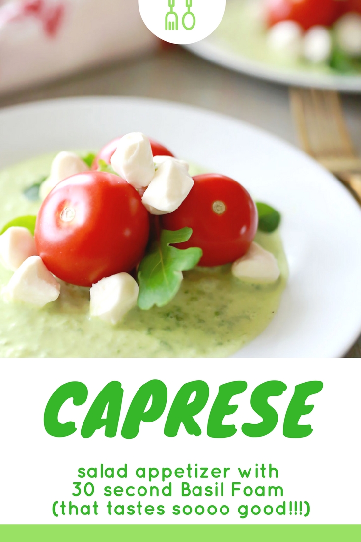 Caprese salad appetizer with fresh Campari tomatoes, spring greens, and mozzarella pearls; all in a vibrantly flavored sweet basil foam.