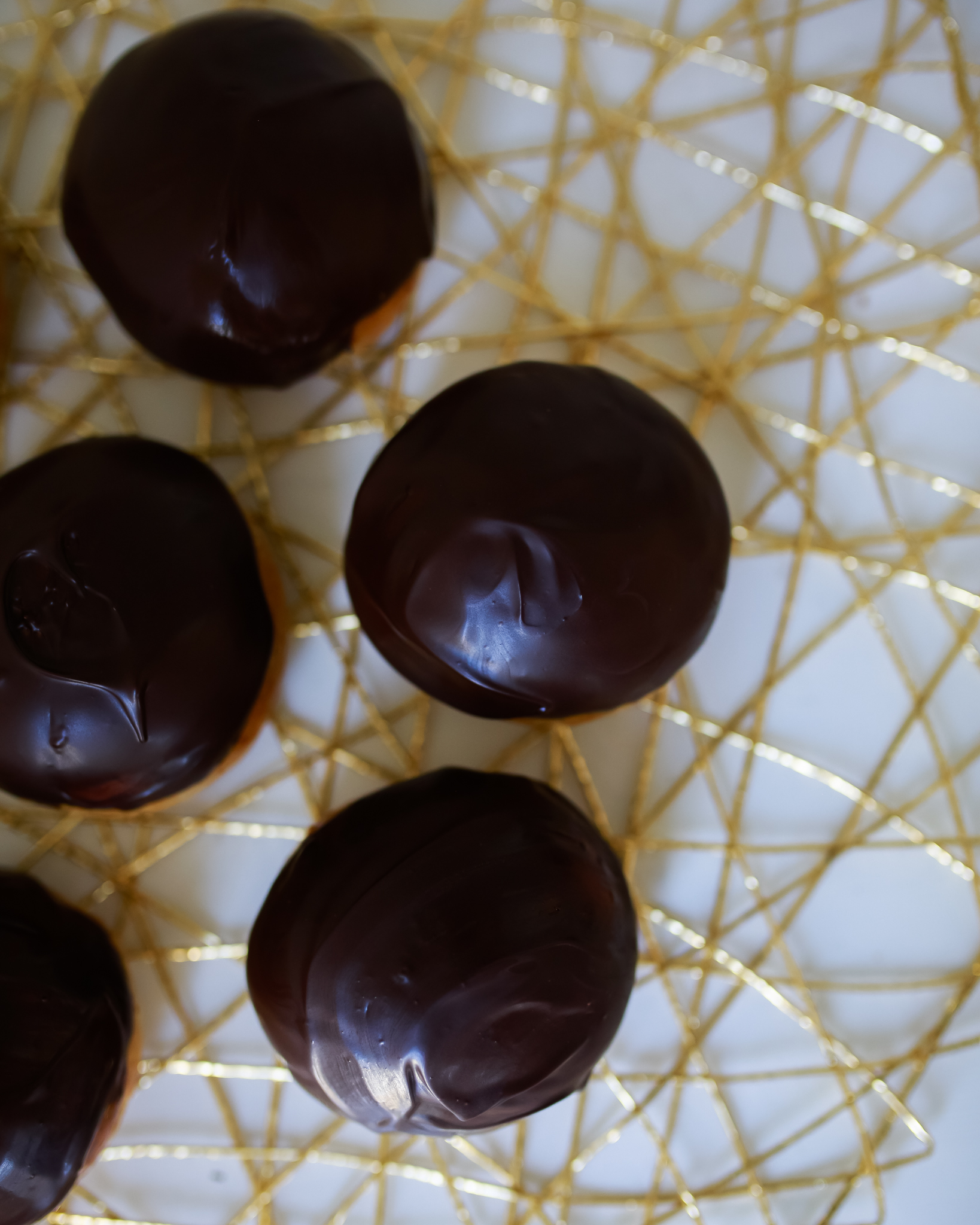 Chocolate dipped sweet buns with a cream filling
